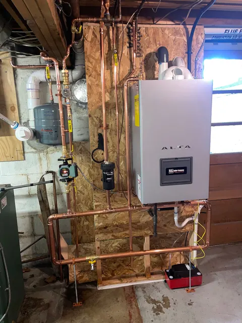 Wall-mounted ALTA boiler with copper pipework, circulation components and an expansion tank.
